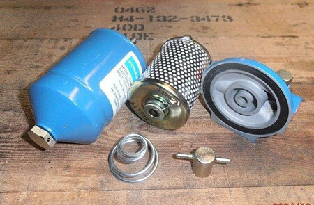 Compact Vokes filter dismantled showing bowl, element, cover seal and spring